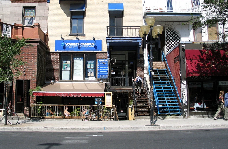 a street scene with buildings and people walking