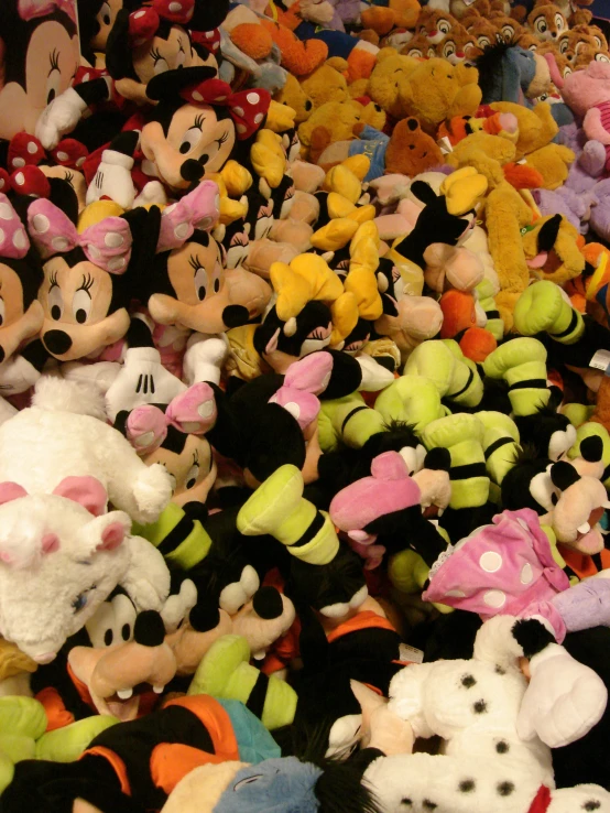 a pile of various colored stuffed toys next to each other