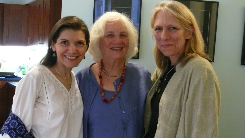 two older women standing beside an older woman with white hair