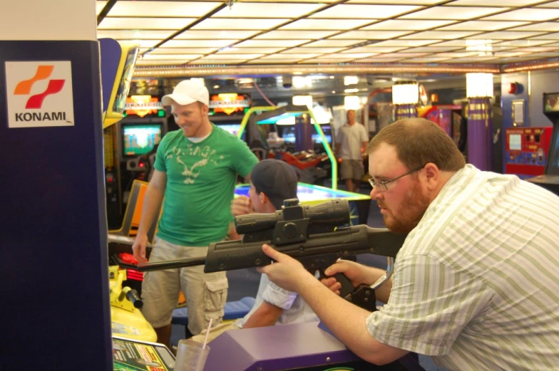 an army style gun is being displayed by some men