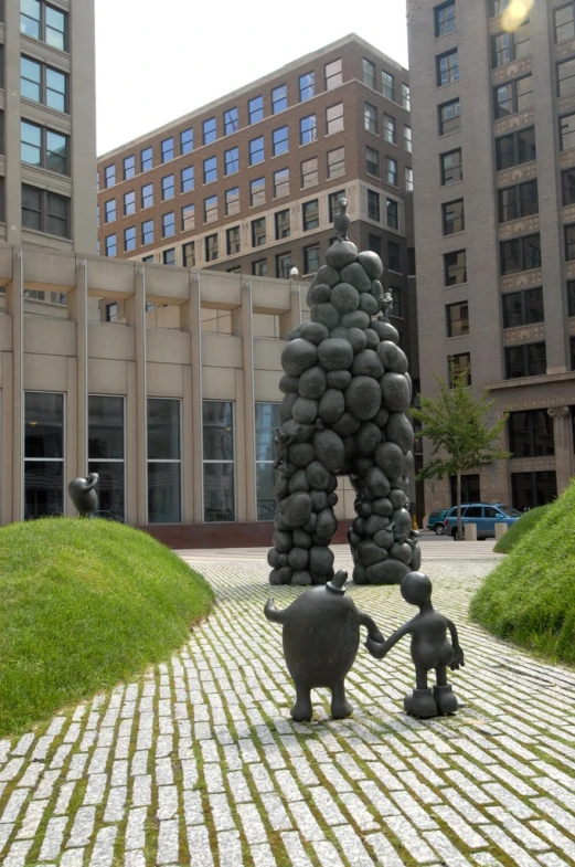 a couple of statues next to each other on a street