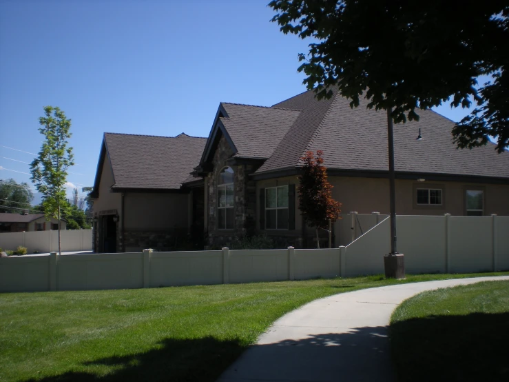 a home with a large tree and several bushes