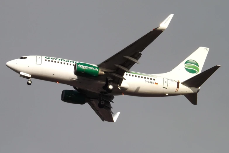 a jet liner flying in the sky with its wheels out