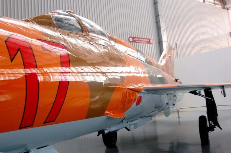 an orange and white airplane with a large nose and two engines