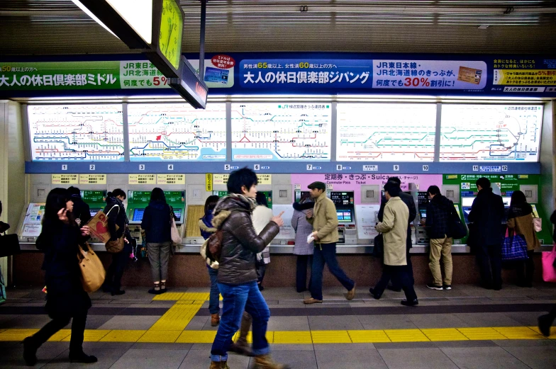 several people in the subway station and some signs