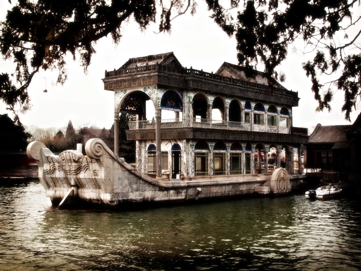 an old, stone boat house sitting on water