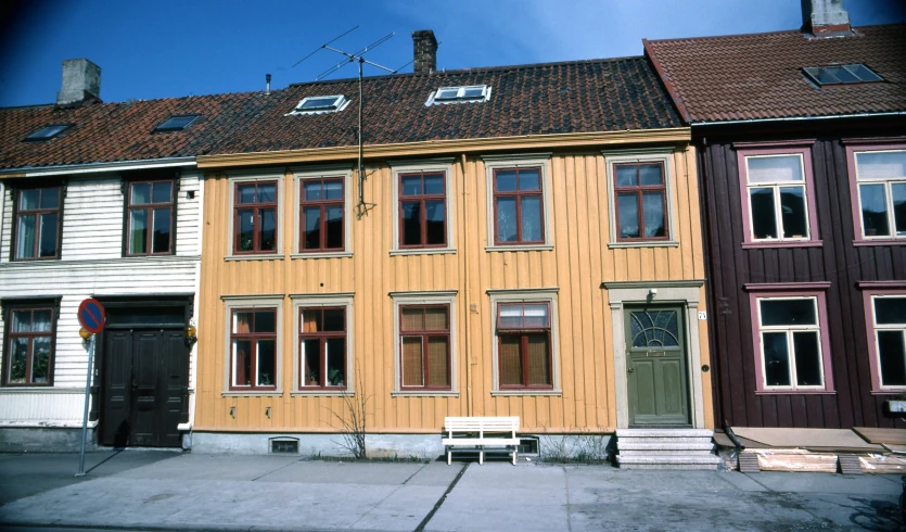 two brown buildings with red and white trim