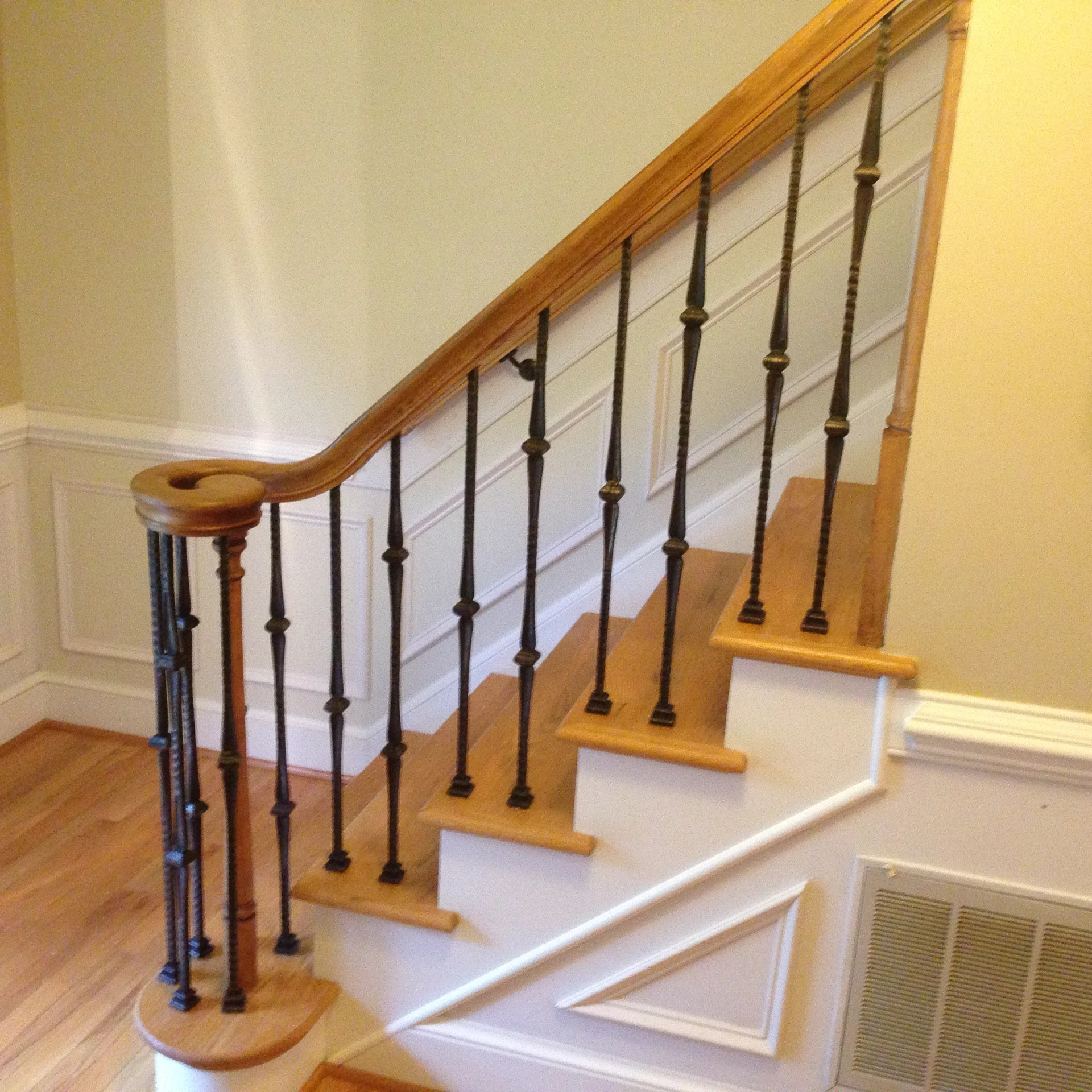 a set of stairs with two wood railings