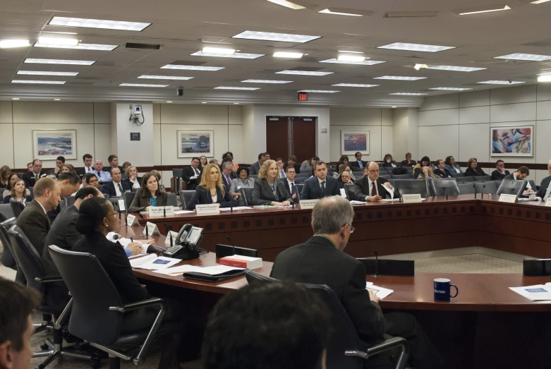 a conference room with many men and women