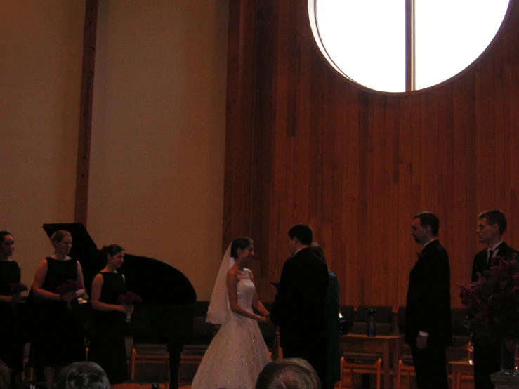 a bride and groom standing next to each other at a wedding