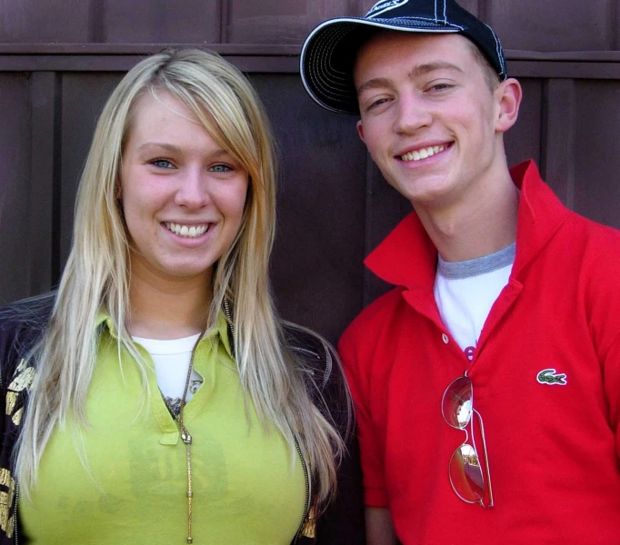 a woman and man wearing hats smiling for the camera