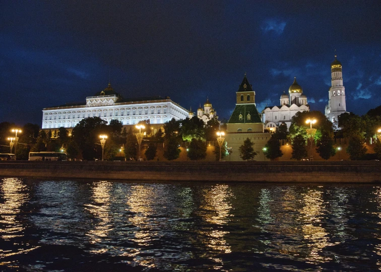 a river view with lights and buildings at night