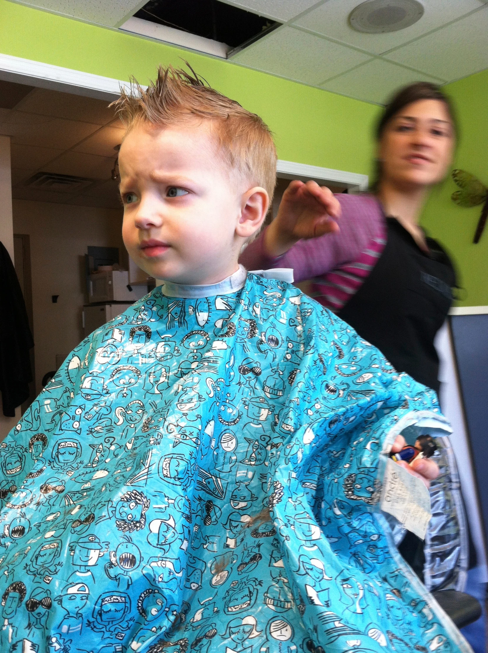 a  having his hair cut in a barber shop