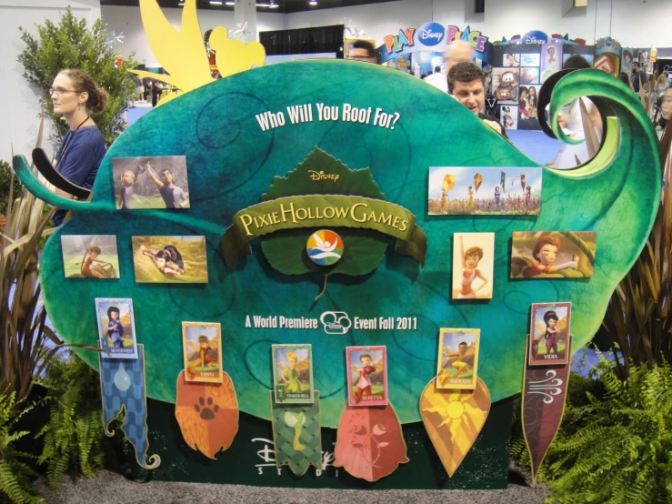 an event display at a convention that shows pictures of children and their parents and the names of characters on it