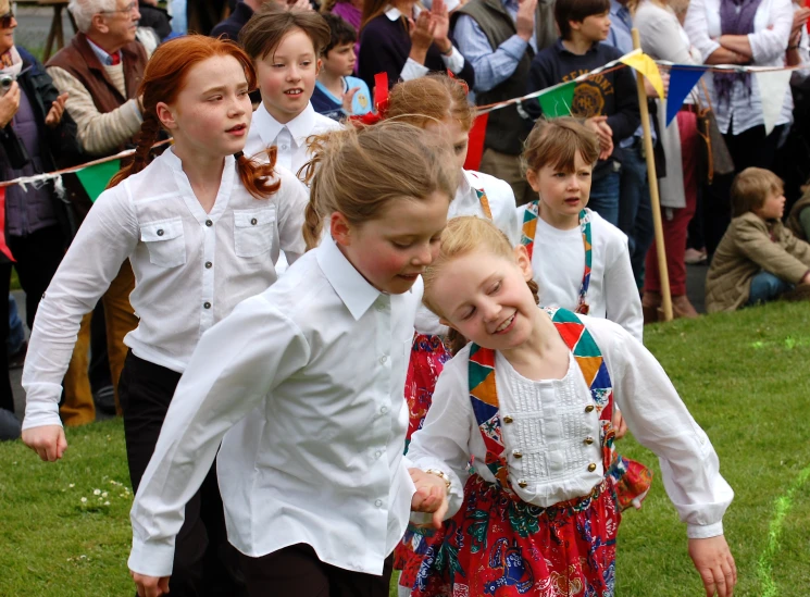 children playing with an item on the field in a school garden