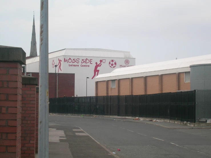 the large soccer stadium has a tall building behind it