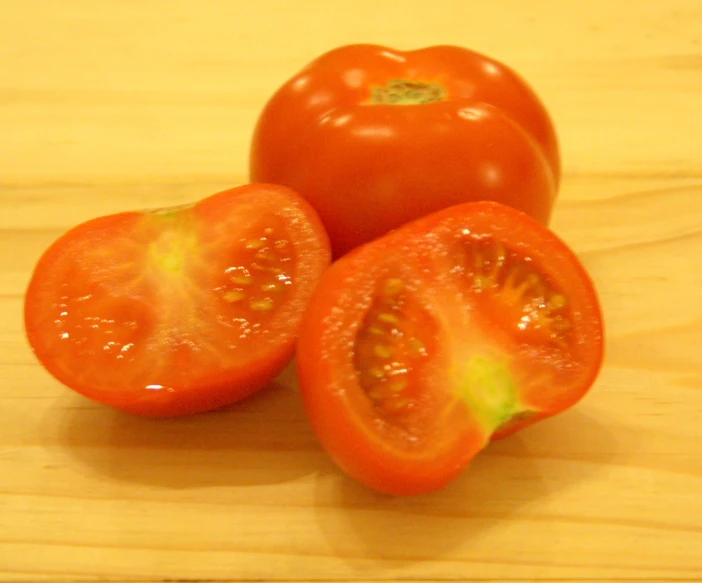 there are tomatoes next to each other on the table