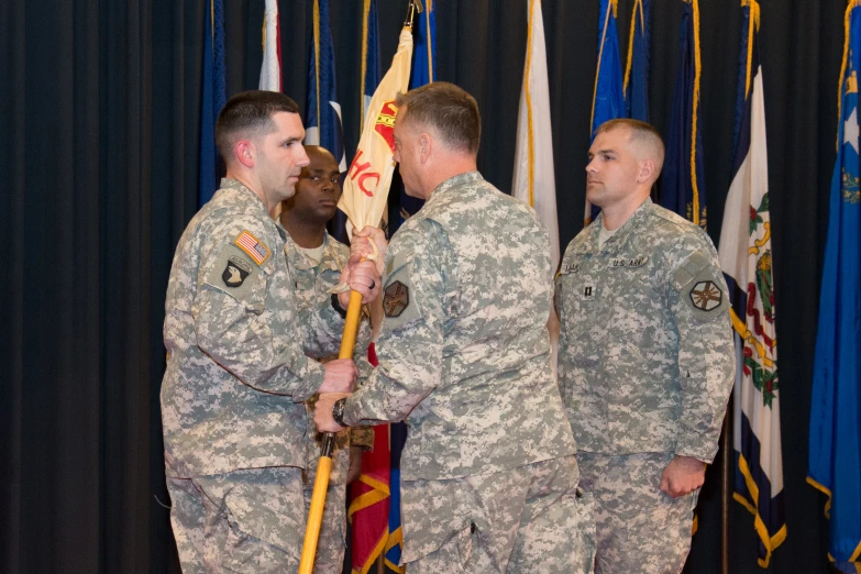 a man in a military uniform holding a pole