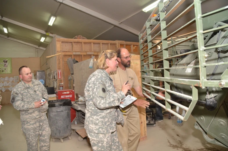 some military men are talking in a shop