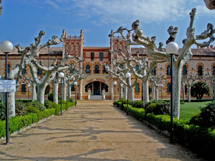 a big building and trees next to a walkway