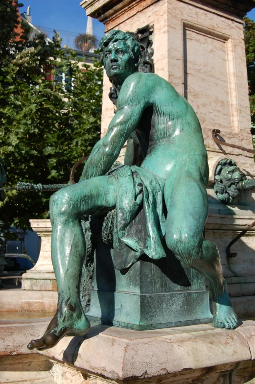 a statue of a boy is holding a bird