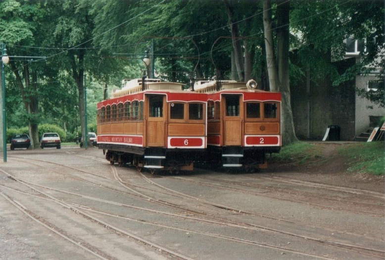 two vintage trains parked next to each other on train tracks