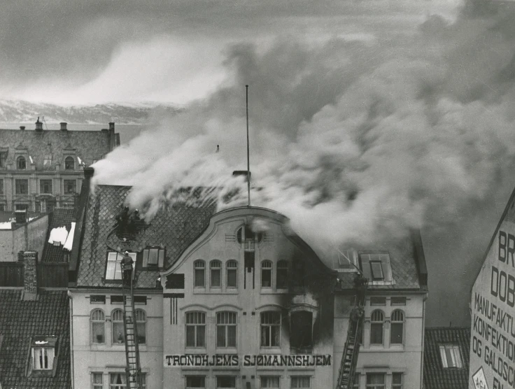 a large building on fire with smoke pouring out the top