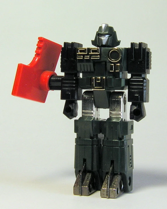 the black robot figure has a red and gray container in his hand