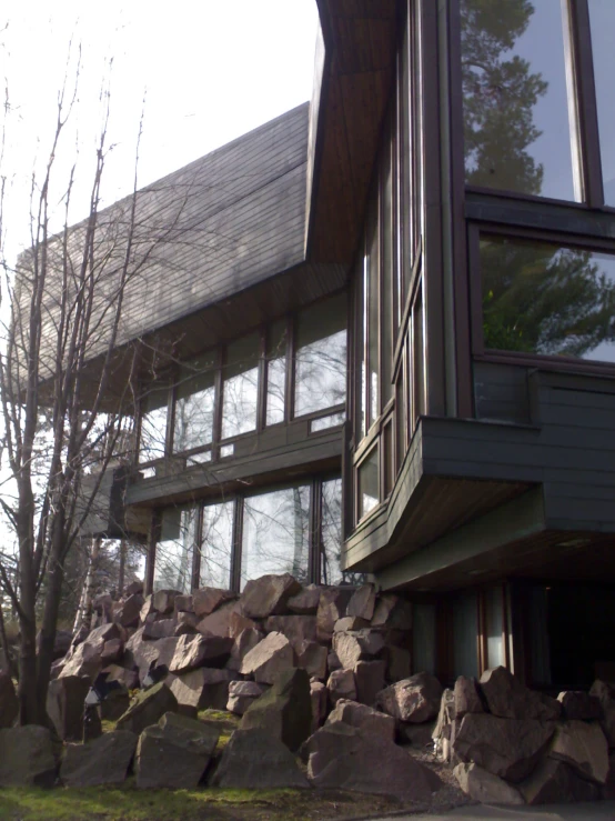 a very large house on some rocks near the road