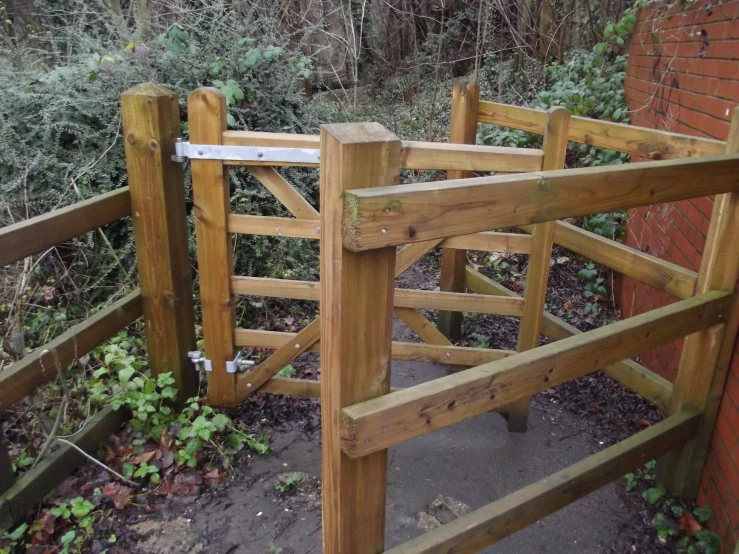 a wooden gate in the side of a brick building