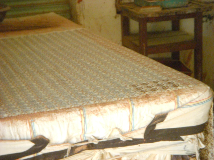 the mattress is covered in a decorative linen