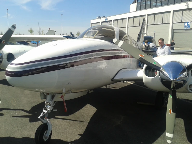 a white plane with people near it