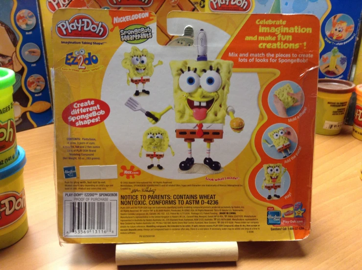 the box of play - doh spongebob is next to its plastic packaging