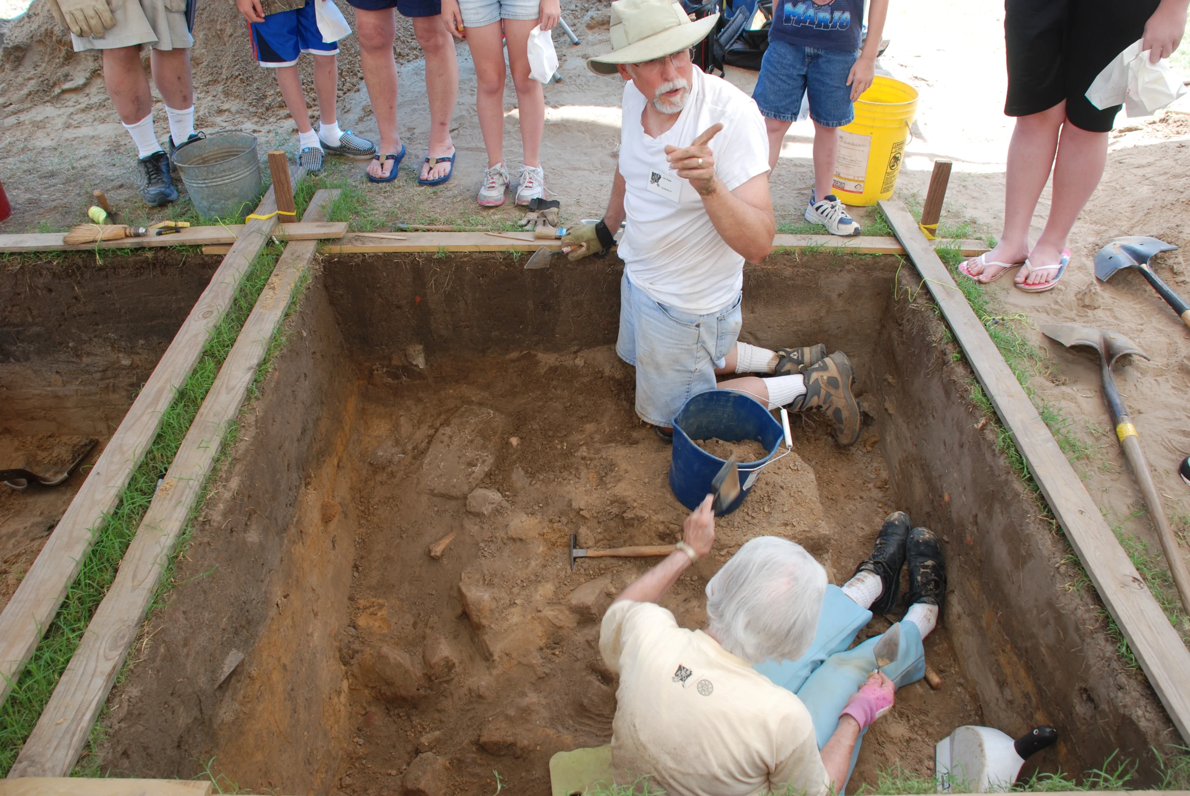 a man is sitting in the ground and his legs are in the dirt