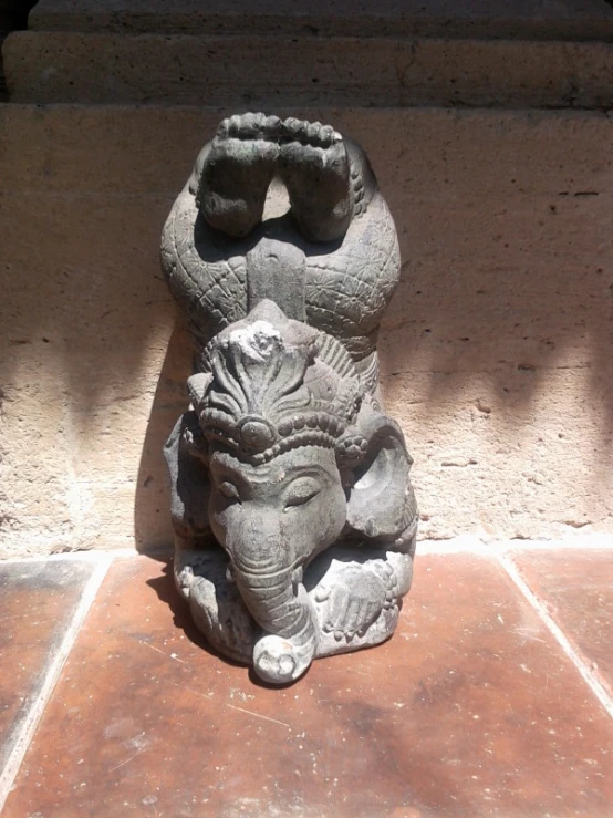 a statue of an elephant with its trunk on it