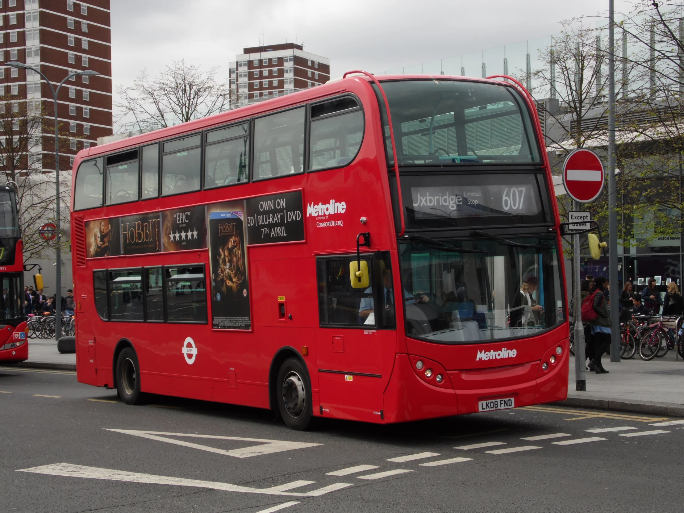 a large double decker bus is stopped on the street