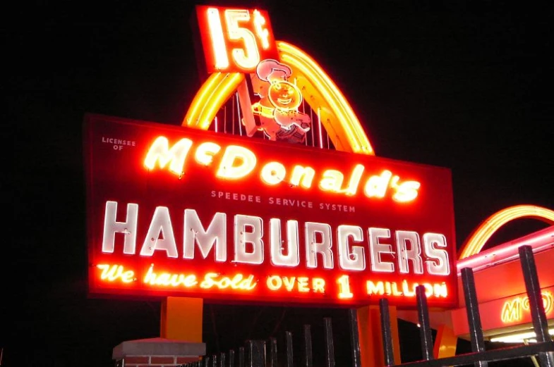 neon sign for hamburger restaurant with burgers coming out