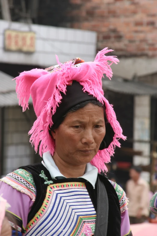 woman wearing an elaborate hat with feather beads on it