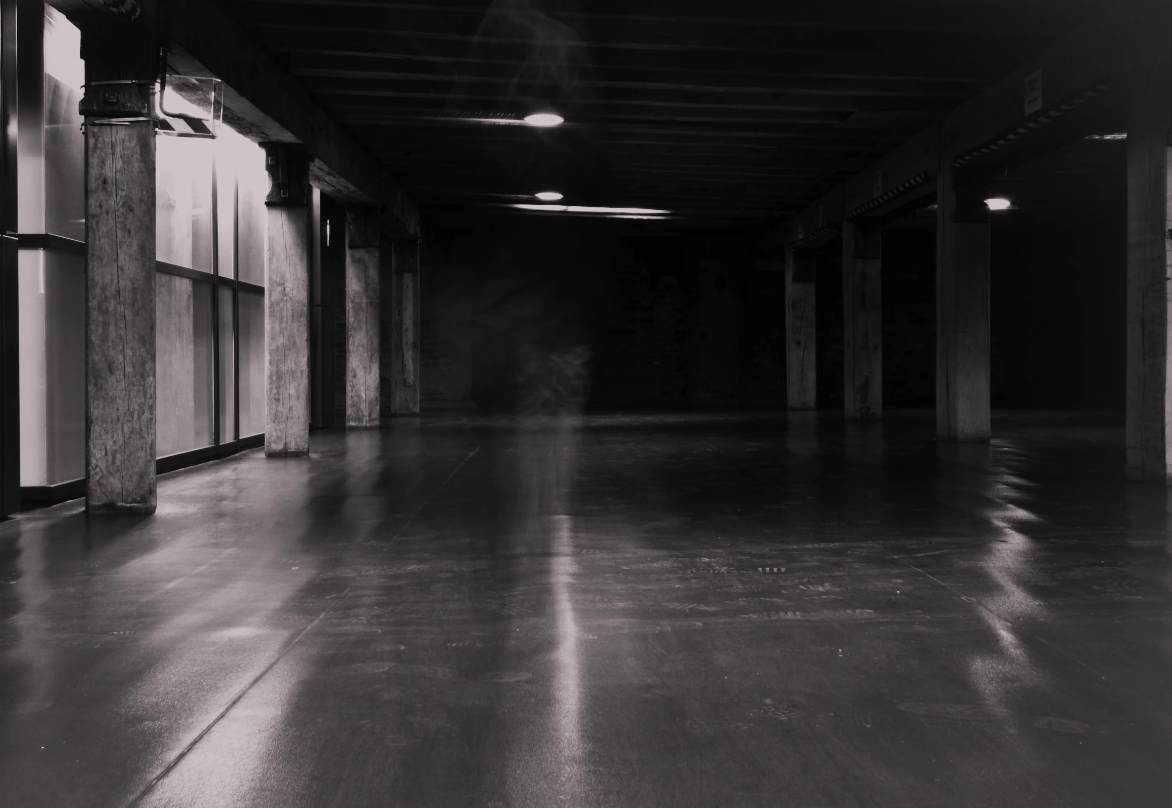 a parking garage in black and white with lots of parking spaces