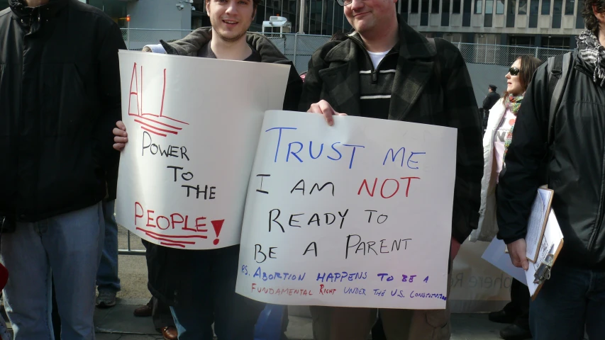 men holding white signs holding up signs that say trust me, i am not the reason to be a friend