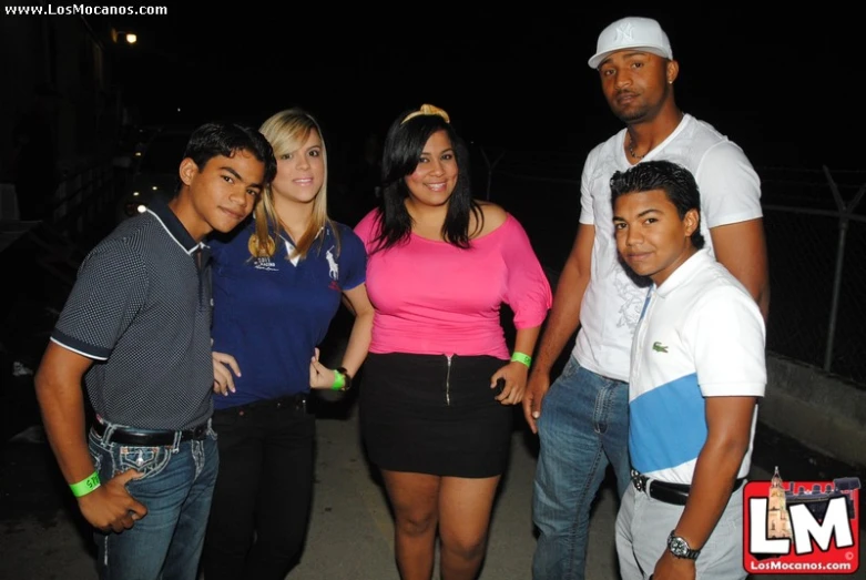 a family standing outside at night posing for a po