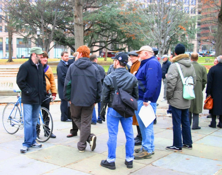 a group of people on the side walk talking