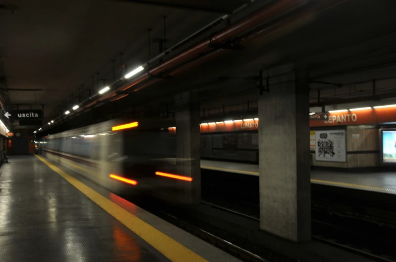 a train with headlights that are going down a track