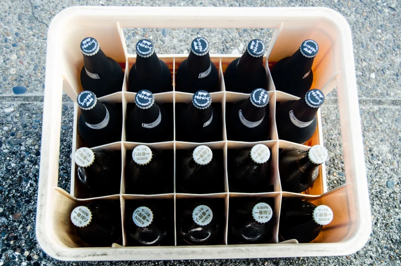 several bottles of various beers sit in a bin