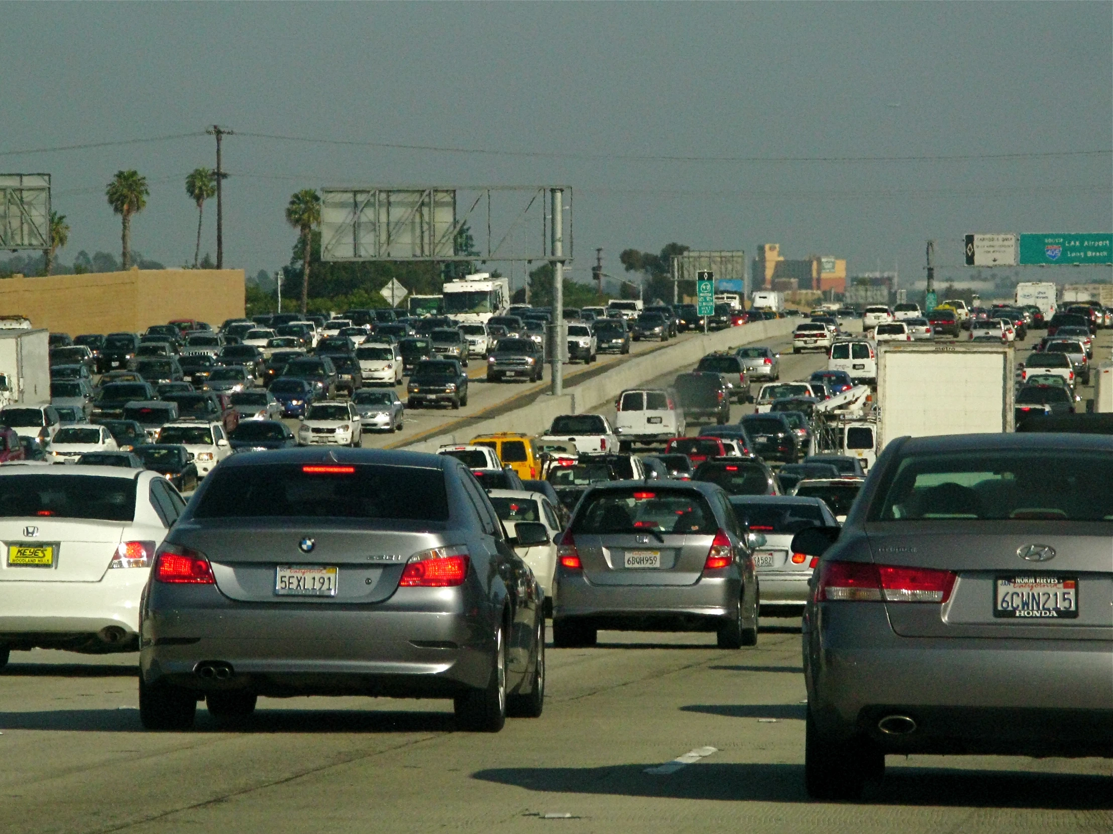 a bunch of cars drive along side of each other