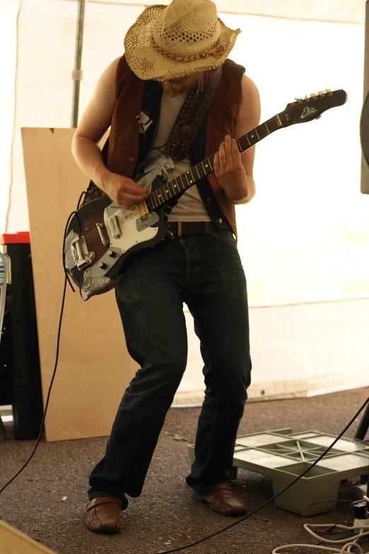 a man is playing an electric guitar on stage