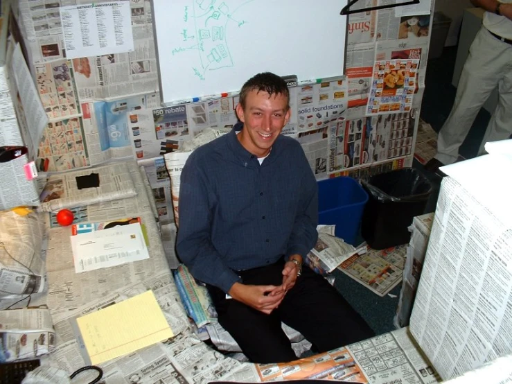 a smiling man in the corner of a room