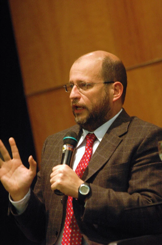 a man in a suit with a microphone