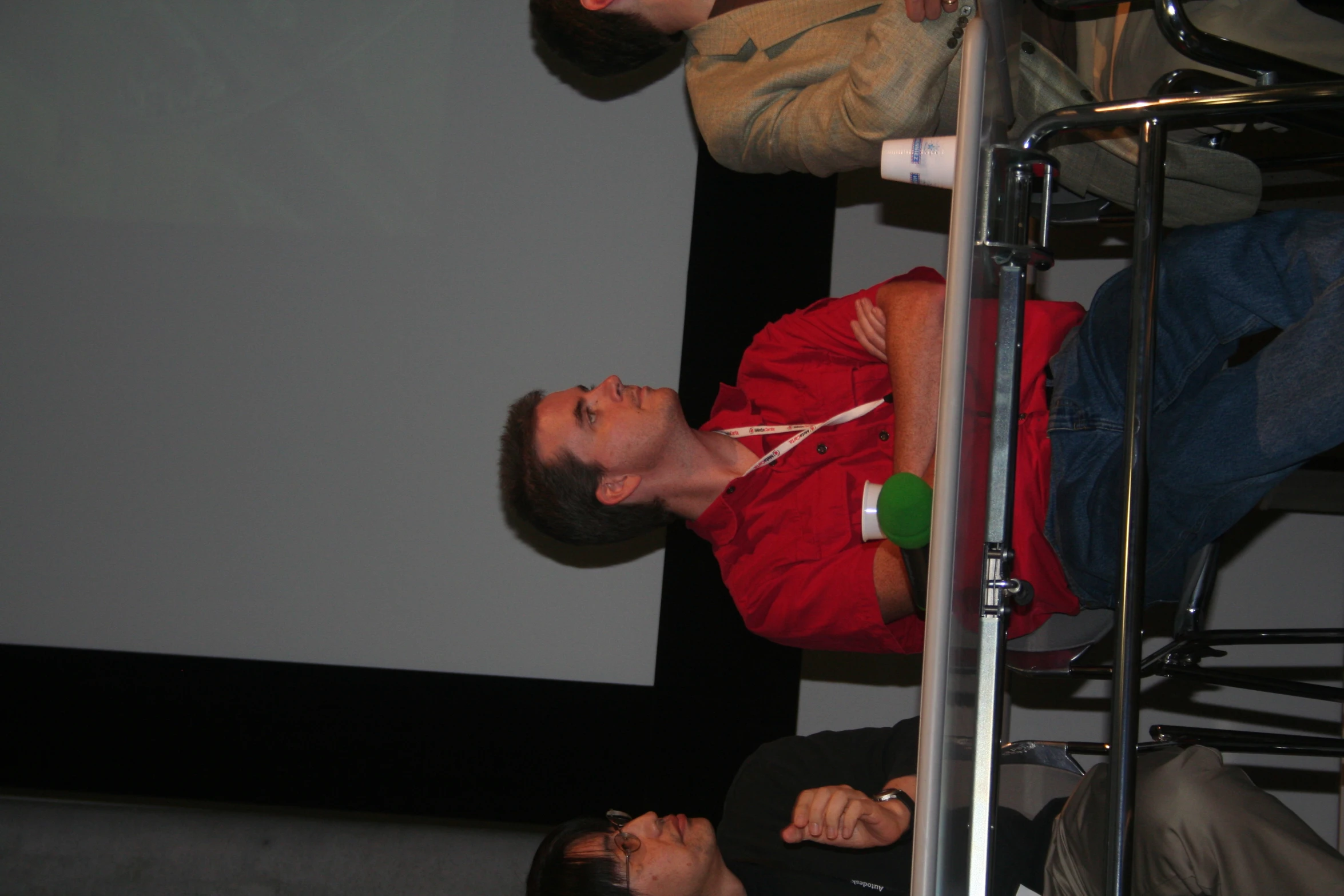 two men sitting side by side watching soing