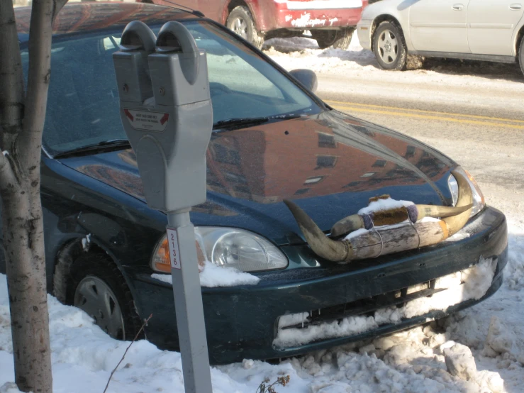 a car that has been badly parked and on the snow